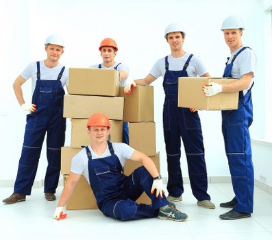 Staff using PPE while handling furniture during a move
