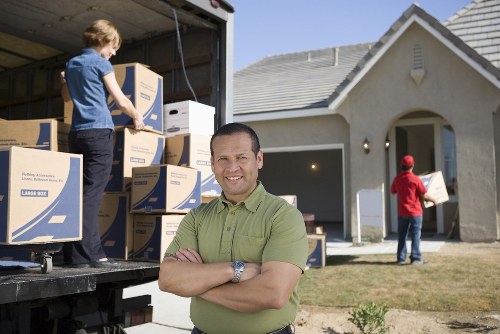 Professional movers handling household belongings carefully